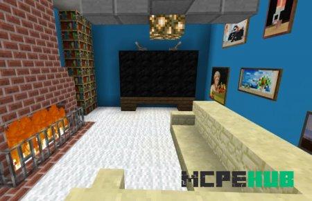 Зал с телевизором, множеством картин и большим диваном возле камина