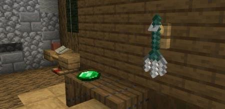 Трезубец, расположенный на стене и изумруд, расположенный на столе