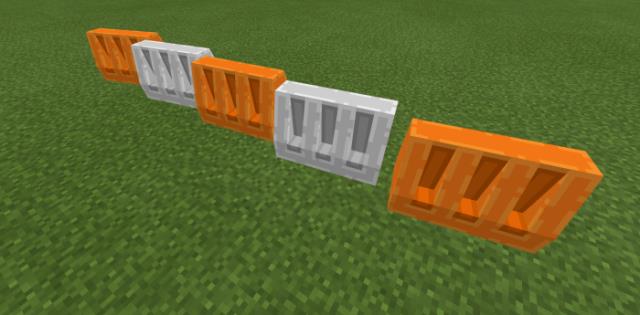 Небольшая стенка из барьеров оранжевого и белого цвета